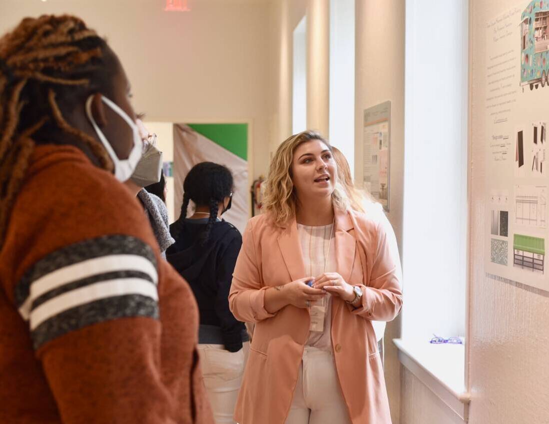 Member of the Salem College community looking at a poster in the fine arts center